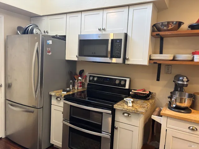 a kitchen with stainless steel appliances a refrigerator stove and sink