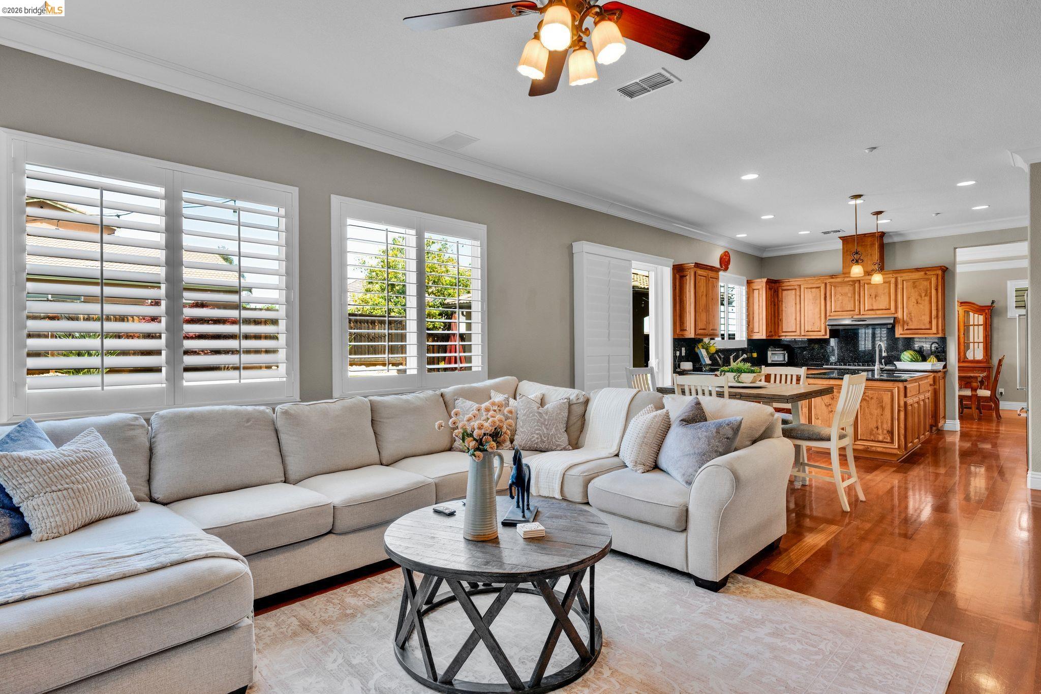 2513 Winged Foot Road Brentwood, CA 94513 - Photo 10 of 45 Living area featuring wood-finish flooring, crown molding, plantation shutters, and recessed lighting