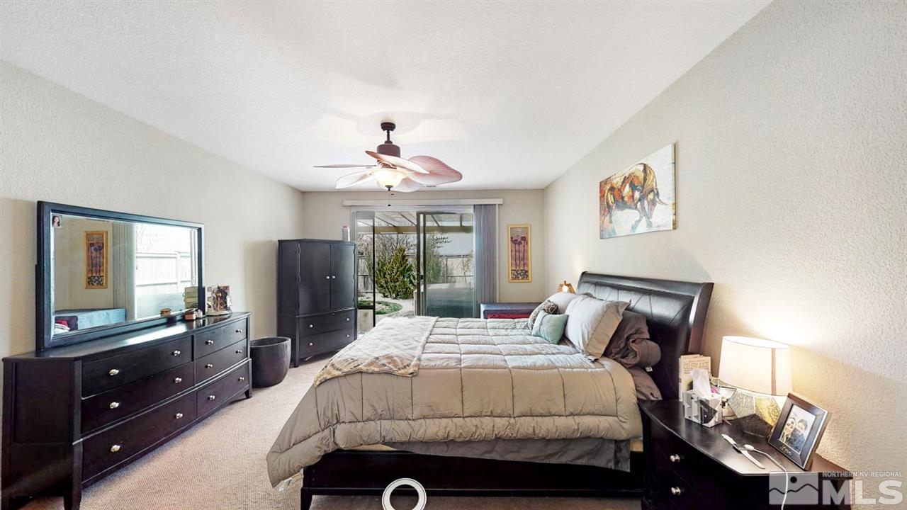 14095 Winners Cup Drive Reno, NV 89521 - Photo 12 of 23 a bedroom with a bed and a mirror on dresser
