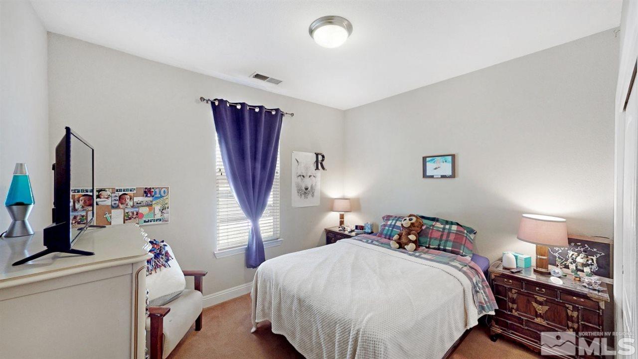 14095 Winners Cup Drive Reno, NV 89521 - Photo 16 of 23 a bedroom with a bed and a dresser