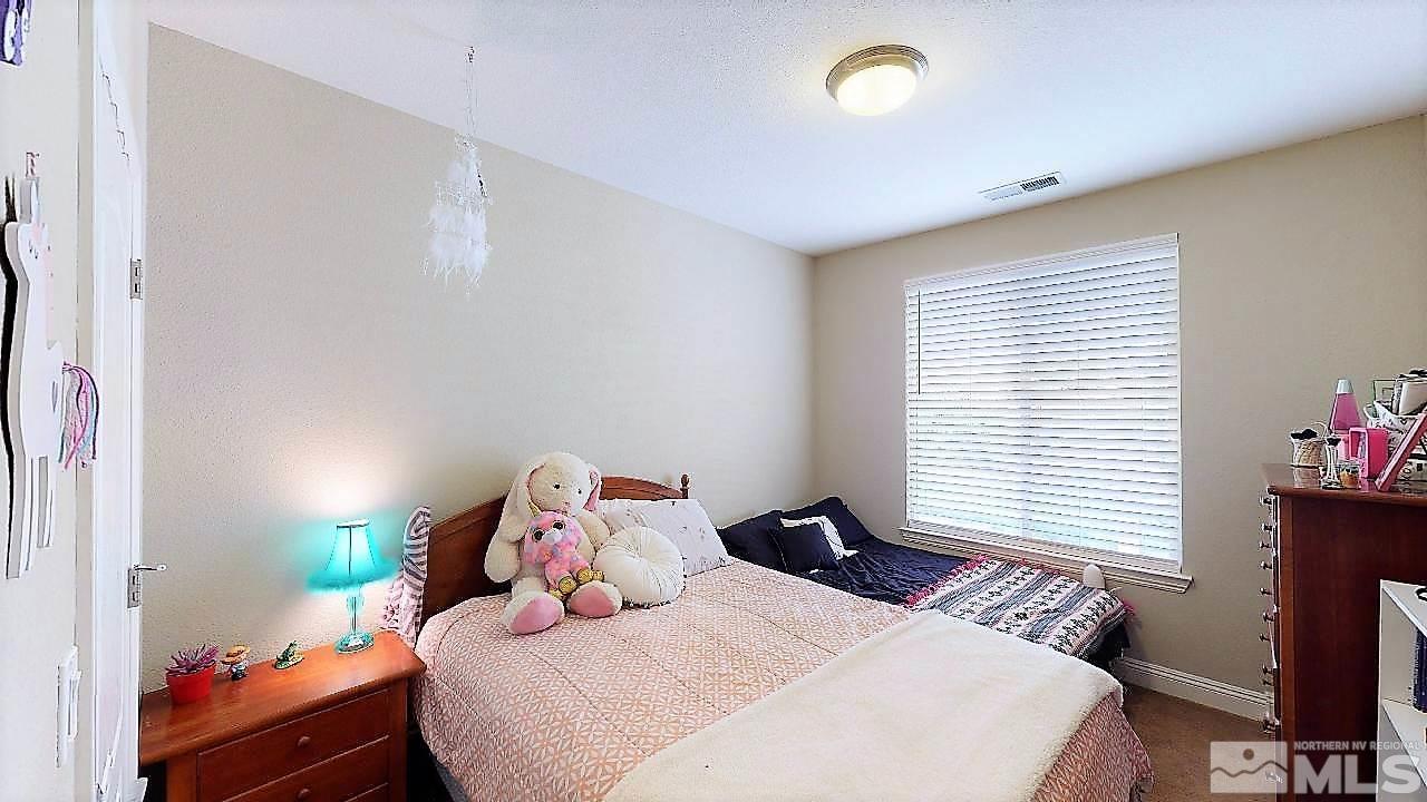 14095 Winners Cup Drive Reno, NV 89521 - Photo 17 of 23 a bedroom with a bed and a window