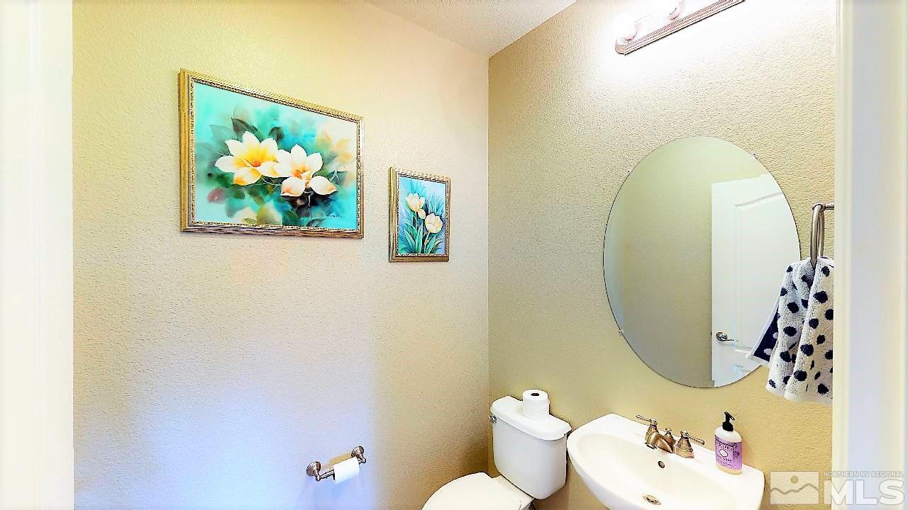 14095 Winners Cup Drive Reno, NV 89521 - Photo 18 of 23 a bathroom with a sink mirror and toilet