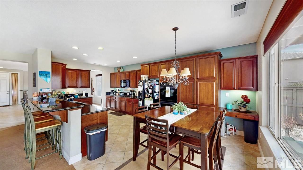 14095 Winners Cup Drive Reno, NV 89521 - Photo 6 of 23 a view of a dining room with furniture window and outside view