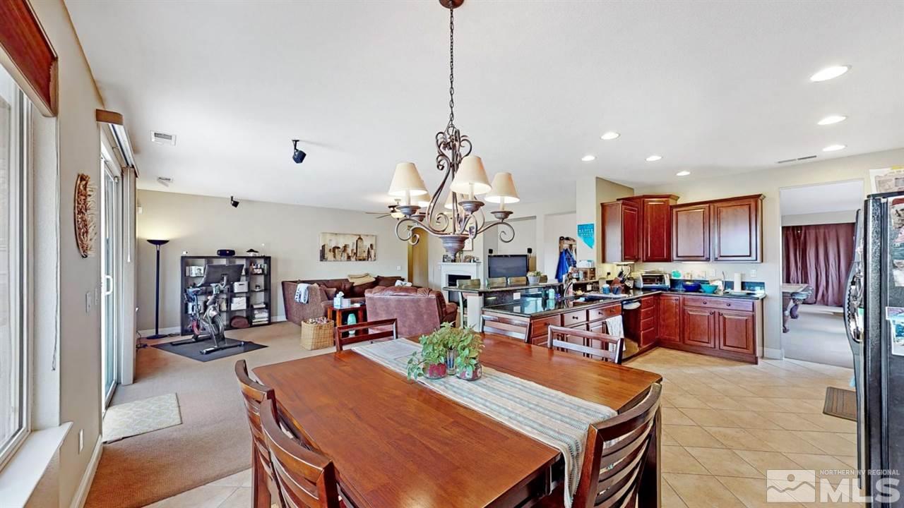 14095 Winners Cup Drive Reno, NV 89521 - Photo 7 of 23 a living room with dining room and kitchen view