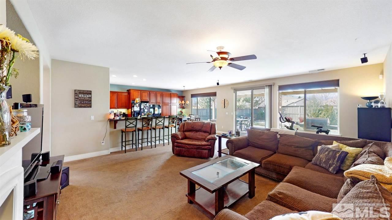 14095 Winners Cup Drive Reno, NV 89521 - Photo 10 of 23 a living room with furniture a ceiling fan and a window