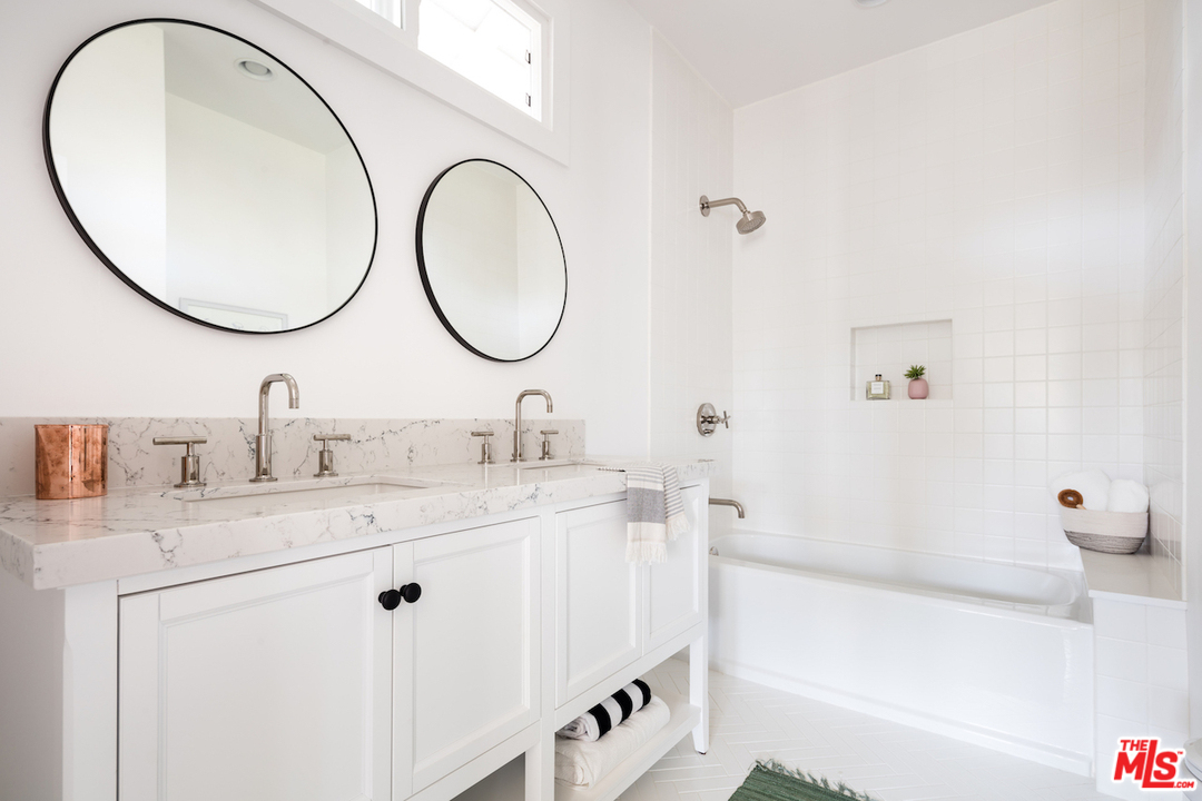 325 Brooks Avenue Venice, CA 90291 - Photo 17 of 25 a bathroom with a sink and a mirror