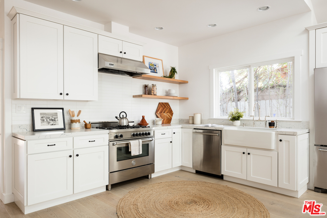 325 Brooks Avenue Venice, CA 90291 - Photo 9 of 25 a kitchen with white cabinets stainless steel appliances and sink