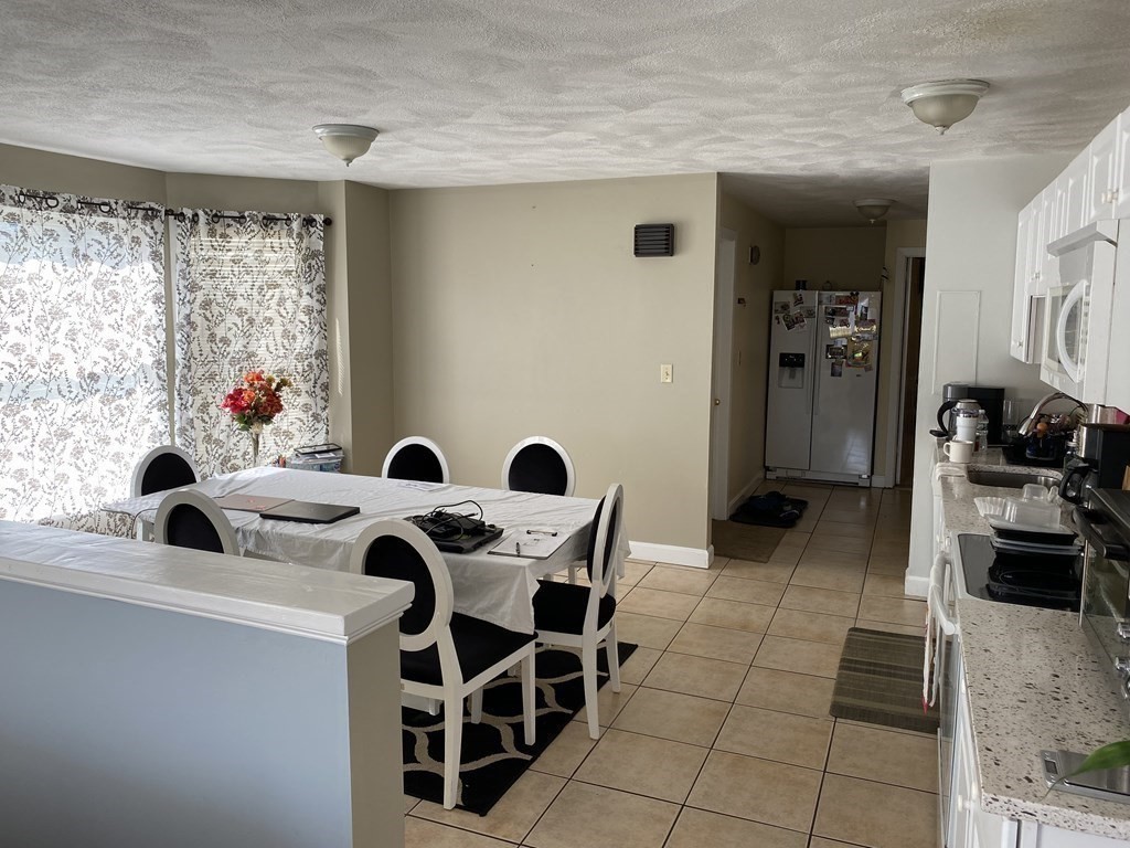 133 Walnut Street, Unit 2 Malden, MA 02148 - Photo 2 of 10 a view of kitchen and dining area with furniture