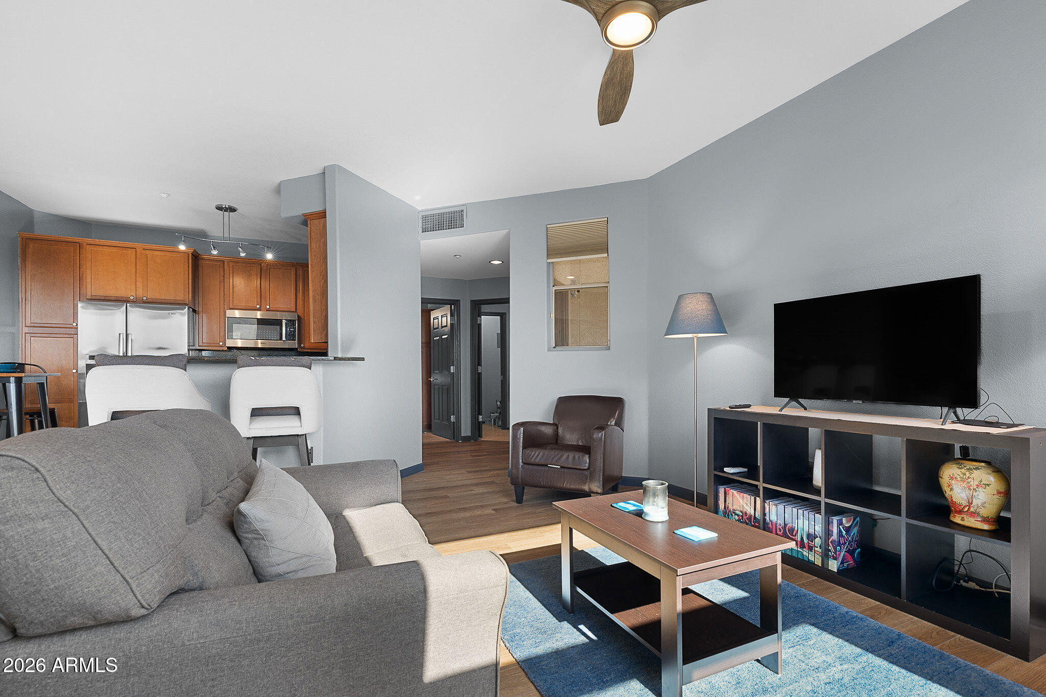 5303 North 7th Street, Unit 331 Phoenix, AZ 85014 - Photo 4 of 39 a living room with furniture and a flat screen tv