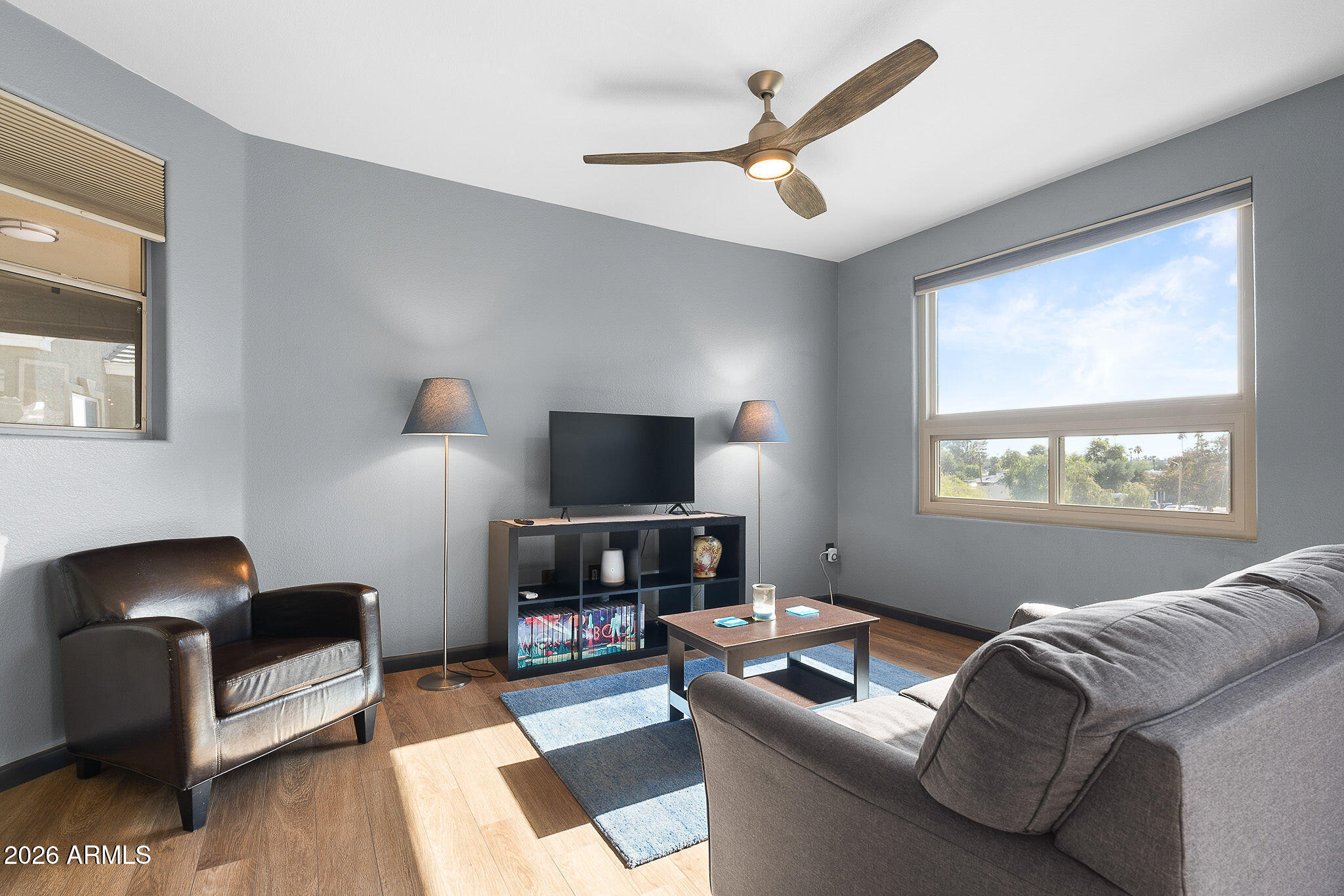 5303 North 7th Street, Unit 331 Phoenix, AZ 85014 - Photo 8 of 39 a living room with furniture and a flat screen tv