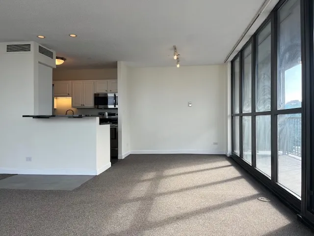 a view of a kitchen with a sink and a refrigerator