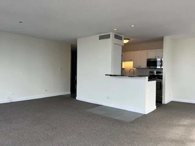 a view of a kitchen with a sink and dishwasher cabinets