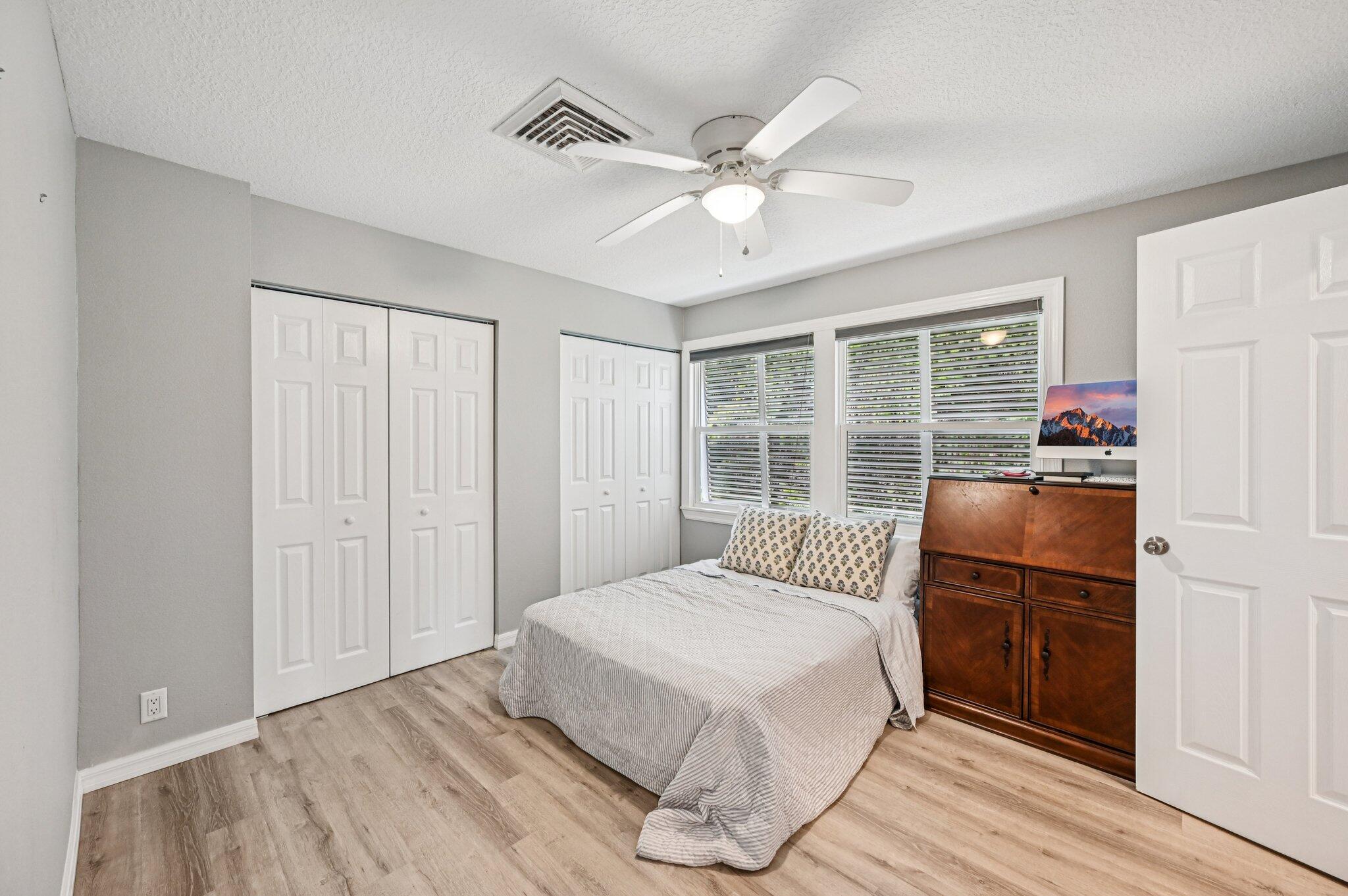 251 Southeast Paradise Place Stuart, FL 34997 - Photo 15 of 39 a bedroom with a large bed and a window