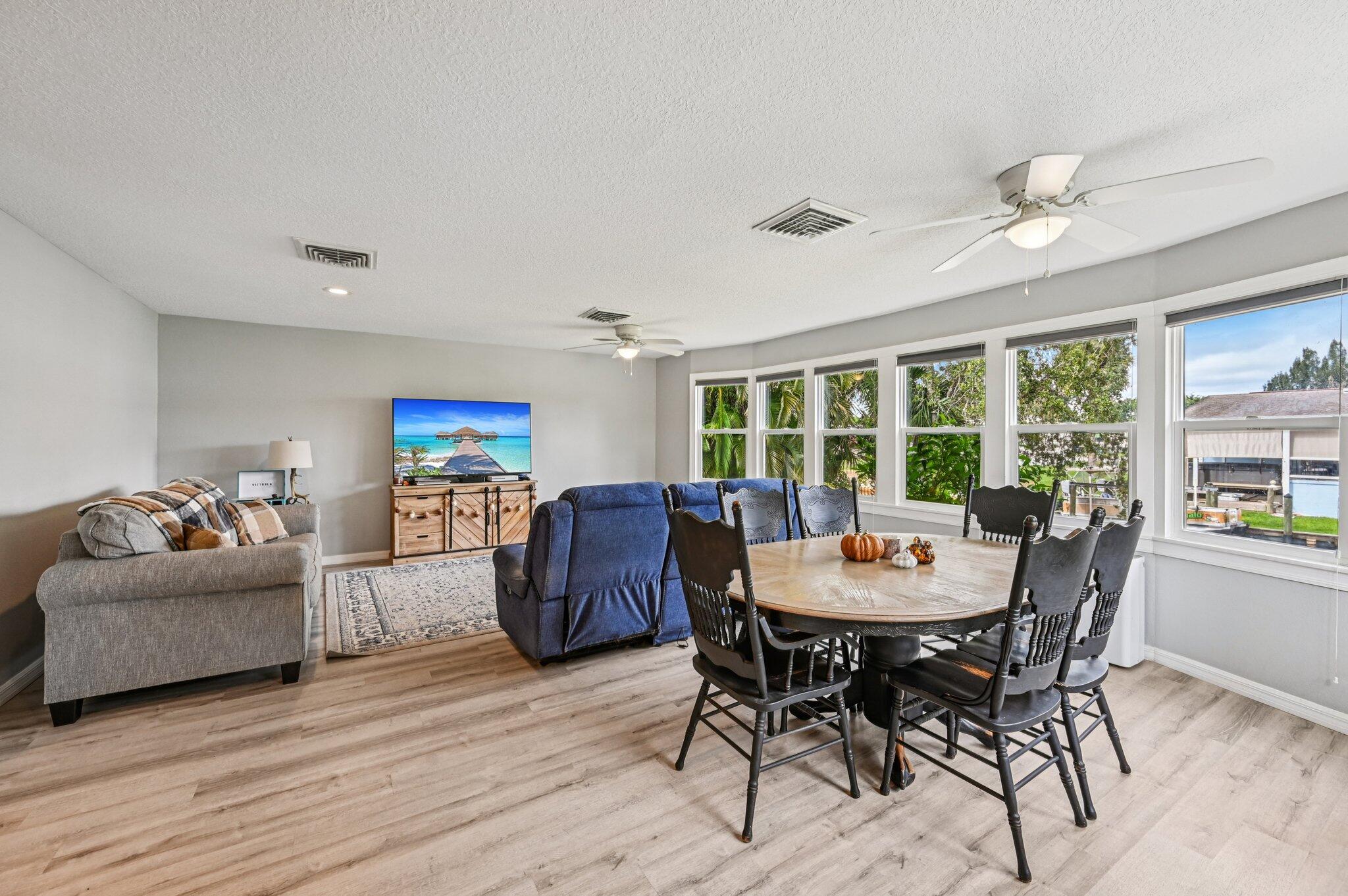 251 Southeast Paradise Place Stuart, FL 34997 - Photo 19 of 39 a view of a dining room with furniture window and wooden floor
