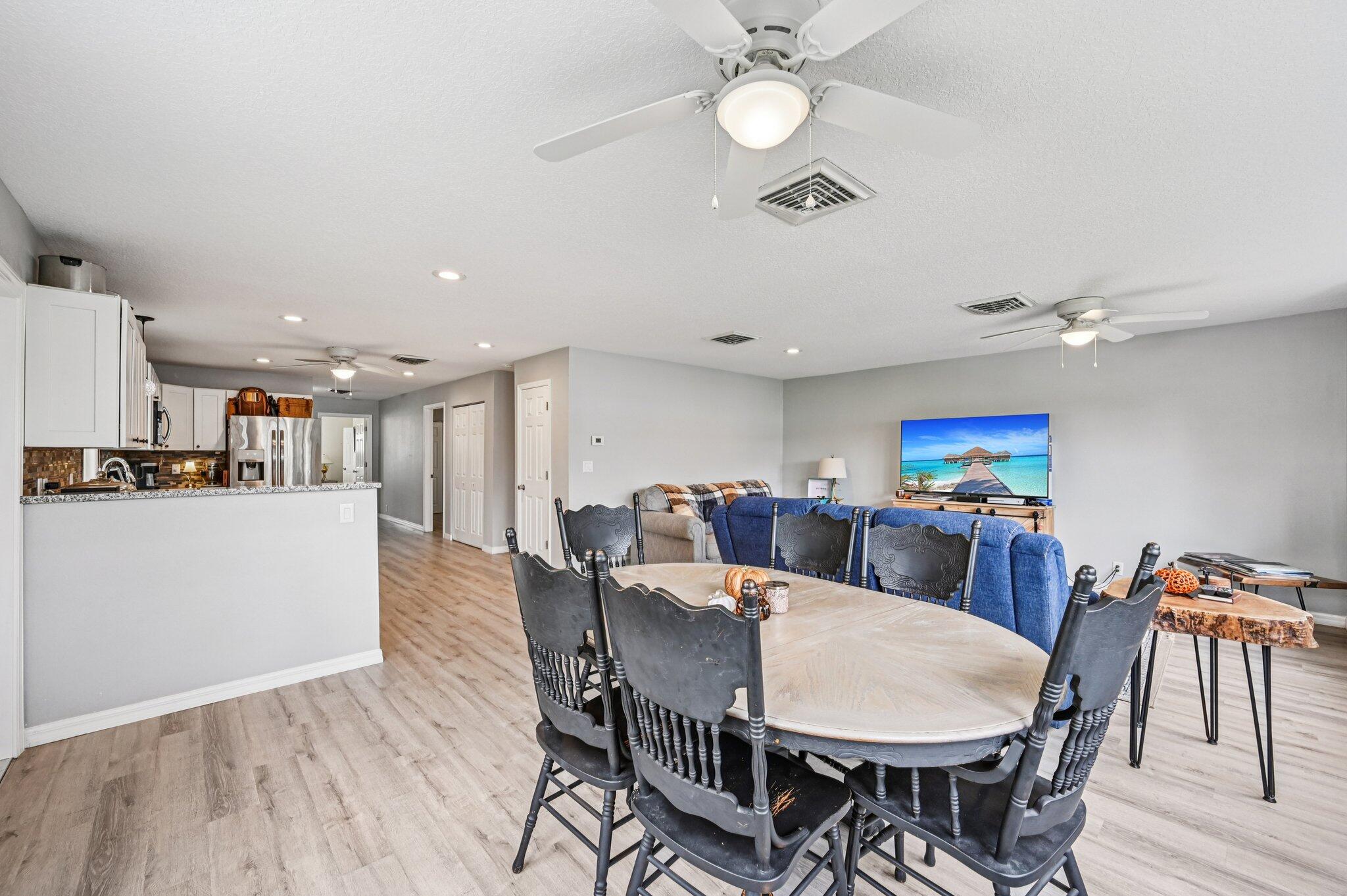 251 Southeast Paradise Place Stuart, FL 34997 - Photo 20 of 39 a view of a dining room with furniture and wooden floor
