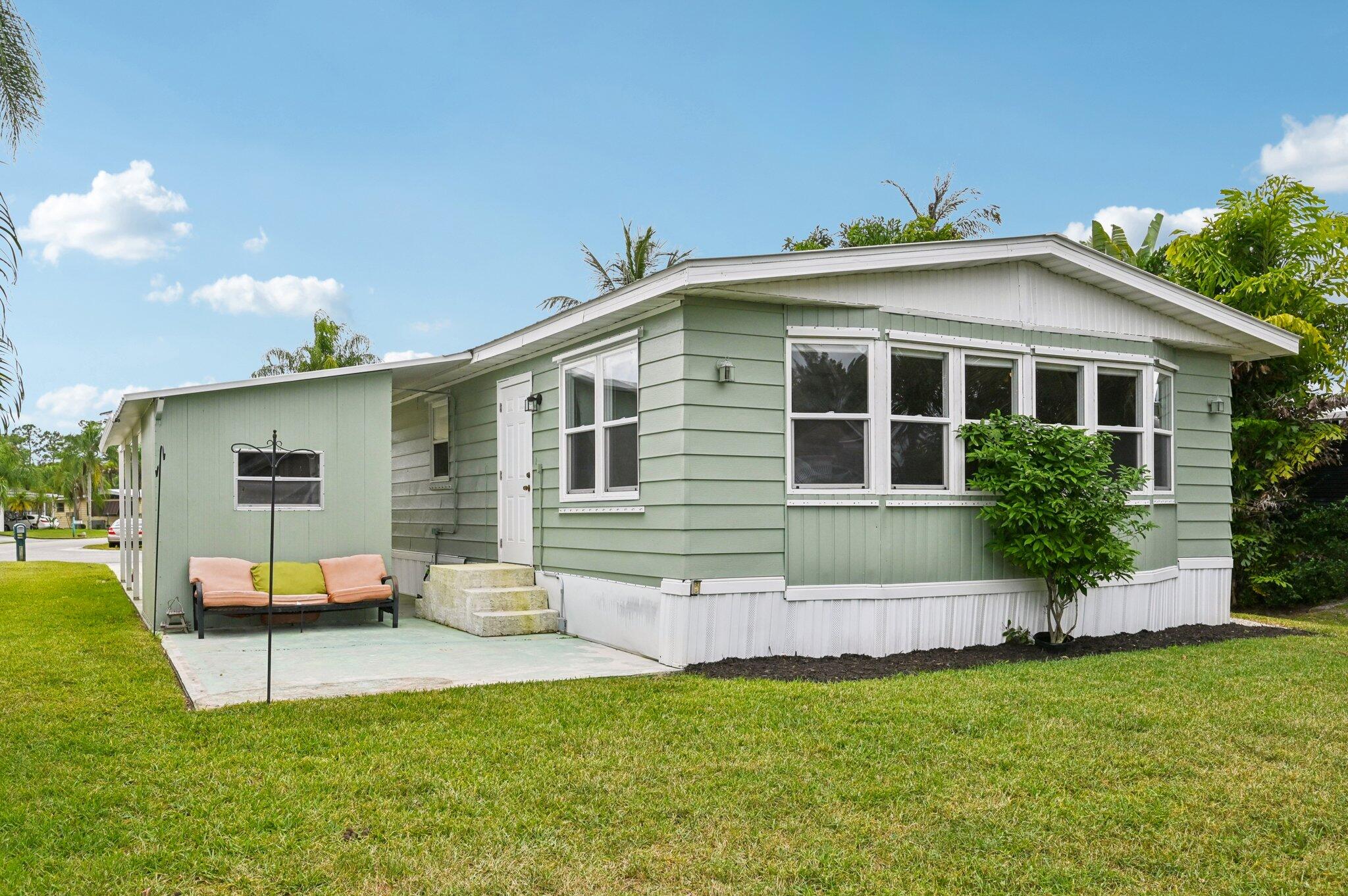 251 Southeast Paradise Place Stuart, FL 34997 - Photo 22 of 39 a front view of house with yard and green space