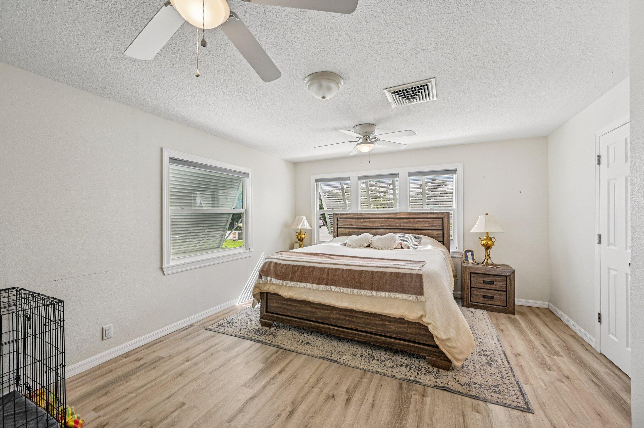 251 Southeast Paradise Place Stuart, FL 34997 - Photo 3 of 39 a bed room with a bed and a window