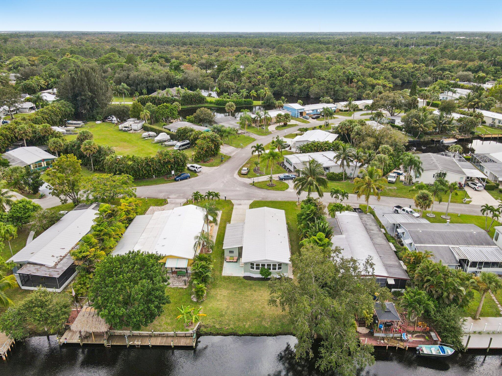 251 Southeast Paradise Place Stuart, FL 34997 - Photo 33 of 39 an aerial view of residential houses with outdoor space and parking