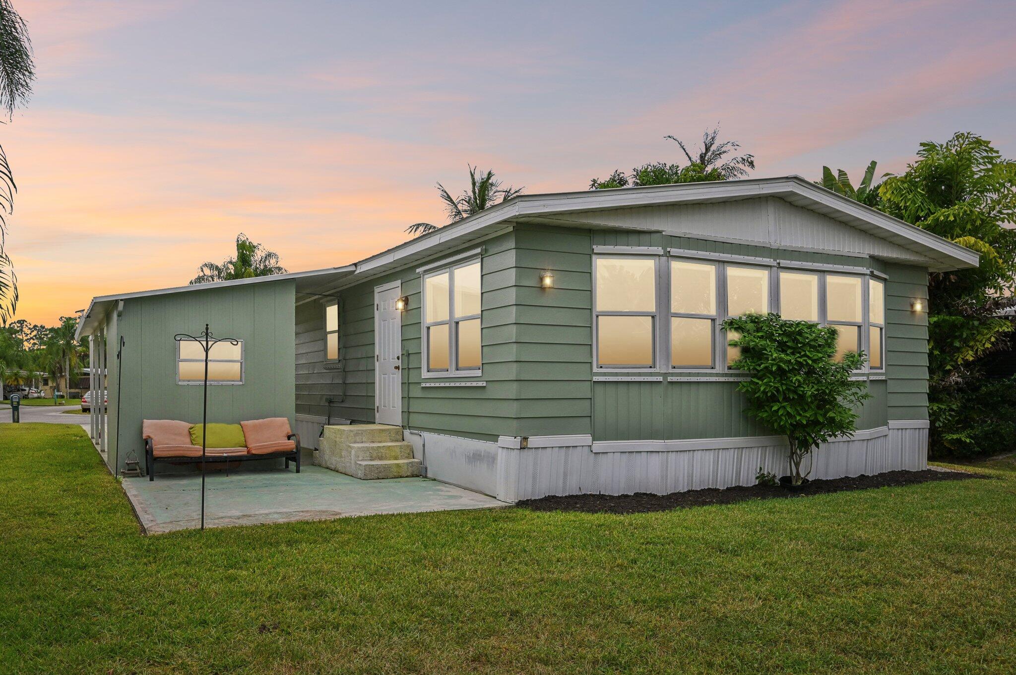 251 Southeast Paradise Place Stuart, FL 34997 - Photo 34 of 39 a front view of a house with garden