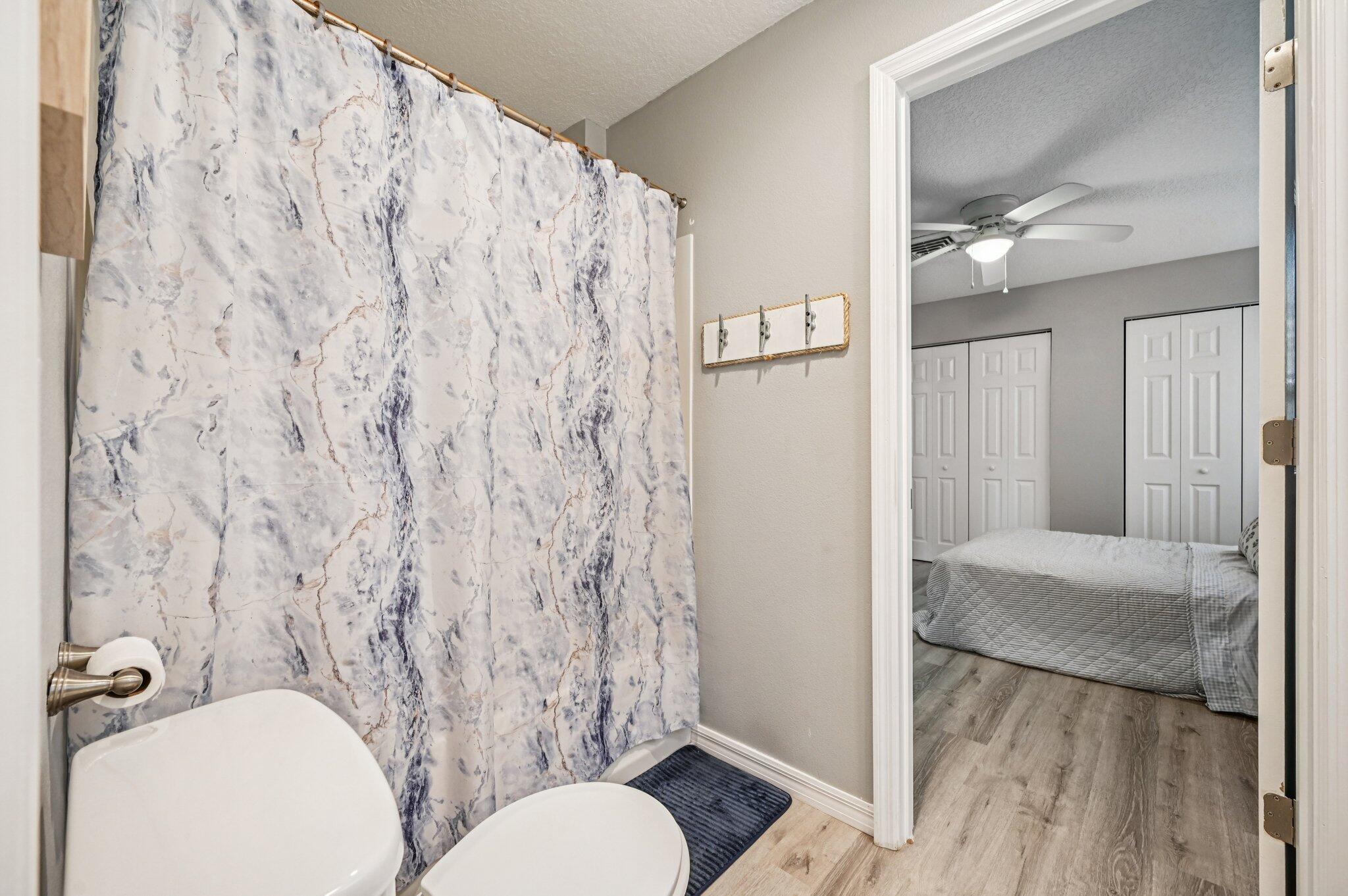 251 Southeast Paradise Place Stuart, FL 34997 - Photo 5 of 39 a bathroom with a toilet and a shower