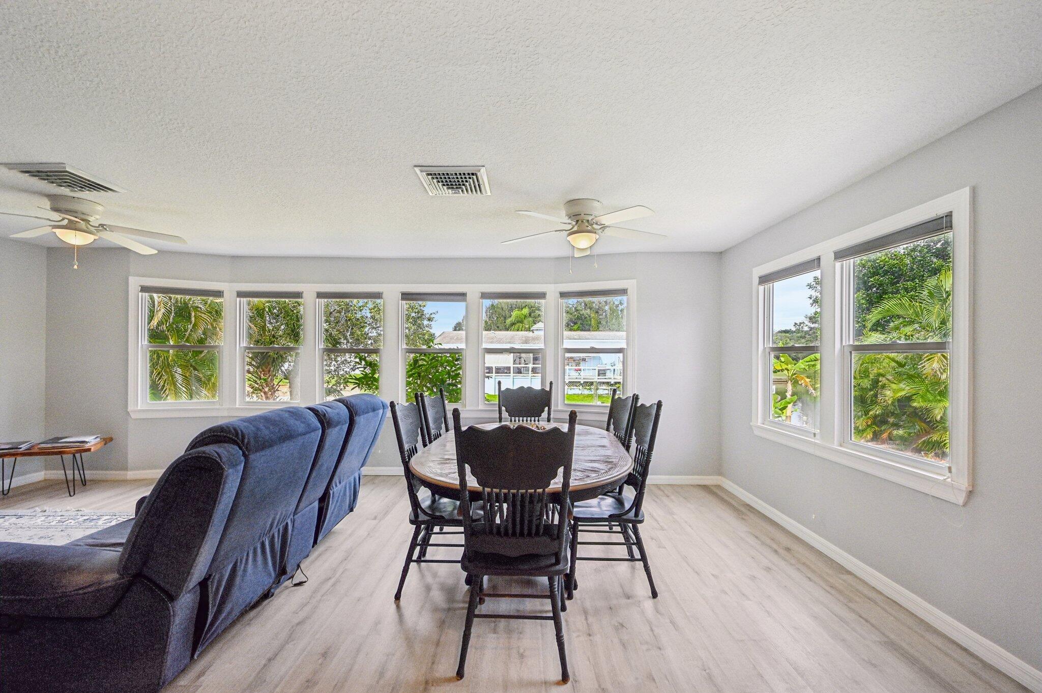 251 Southeast Paradise Place Stuart, FL 34997 - Photo 7 of 39 a dining room with furniture window outside view and wooden floor