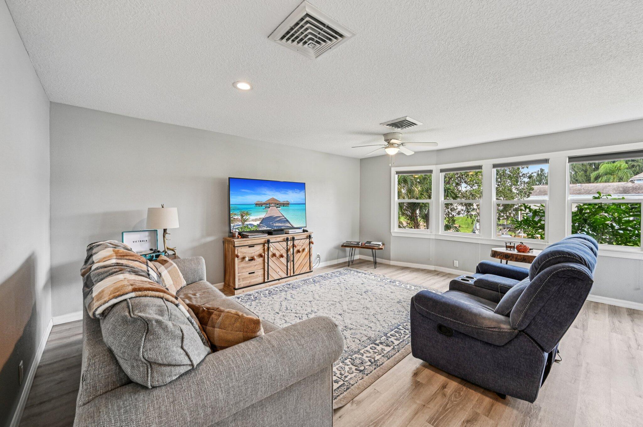 251 Southeast Paradise Place Stuart, FL 34997 - Photo 8 of 39 a living room with furniture and a large window