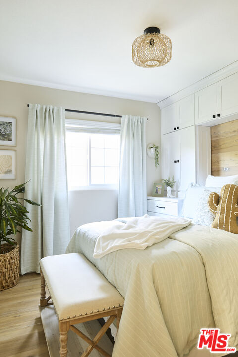 358 Via Metates Oceanside, CA 92057 - Photo 17 of 29 a bedroom with a bed and a chandelier