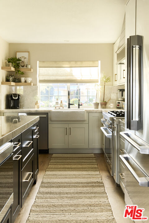 358 Via Metates Oceanside, CA 92057 - Photo 8 of 29 a kitchen with stainless steel appliances granite countertop a sink stove and refrigerator