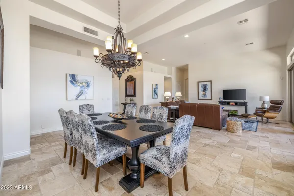 a dining room with furniture a chandelier and window