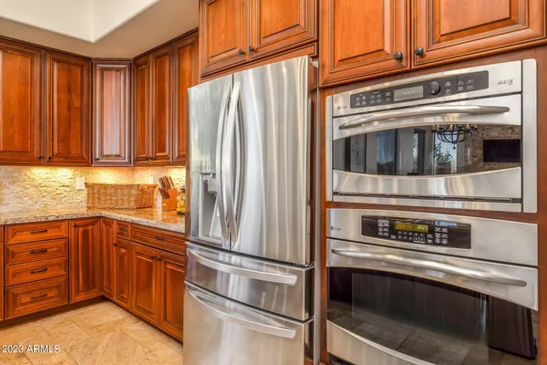 a kitchen with stainless steel appliances and cabinets