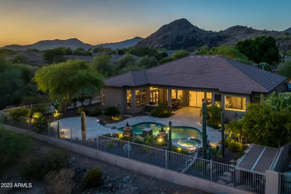 a living room with furniture a floor to ceiling window and potted plants