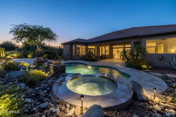 an aerial view of a house with a swimming pool patio and outdoor seating