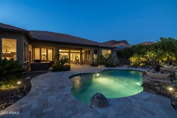 a view of a house with swimming pool and a yard