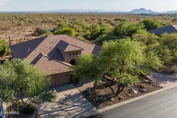 an aerial view of a house with a yard and lake view
