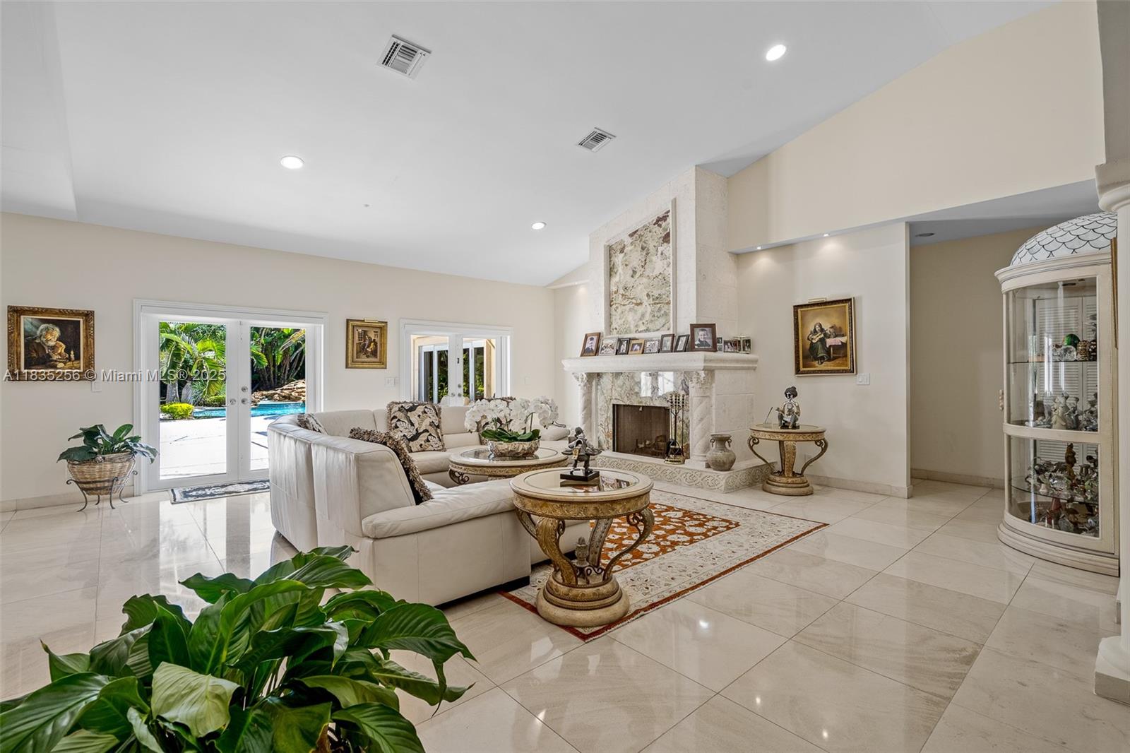 10735 Southwest 58th Avenue Pinecrest, FL 33156 - Photo 11 of 75 a living room with furniture fireplace and a table