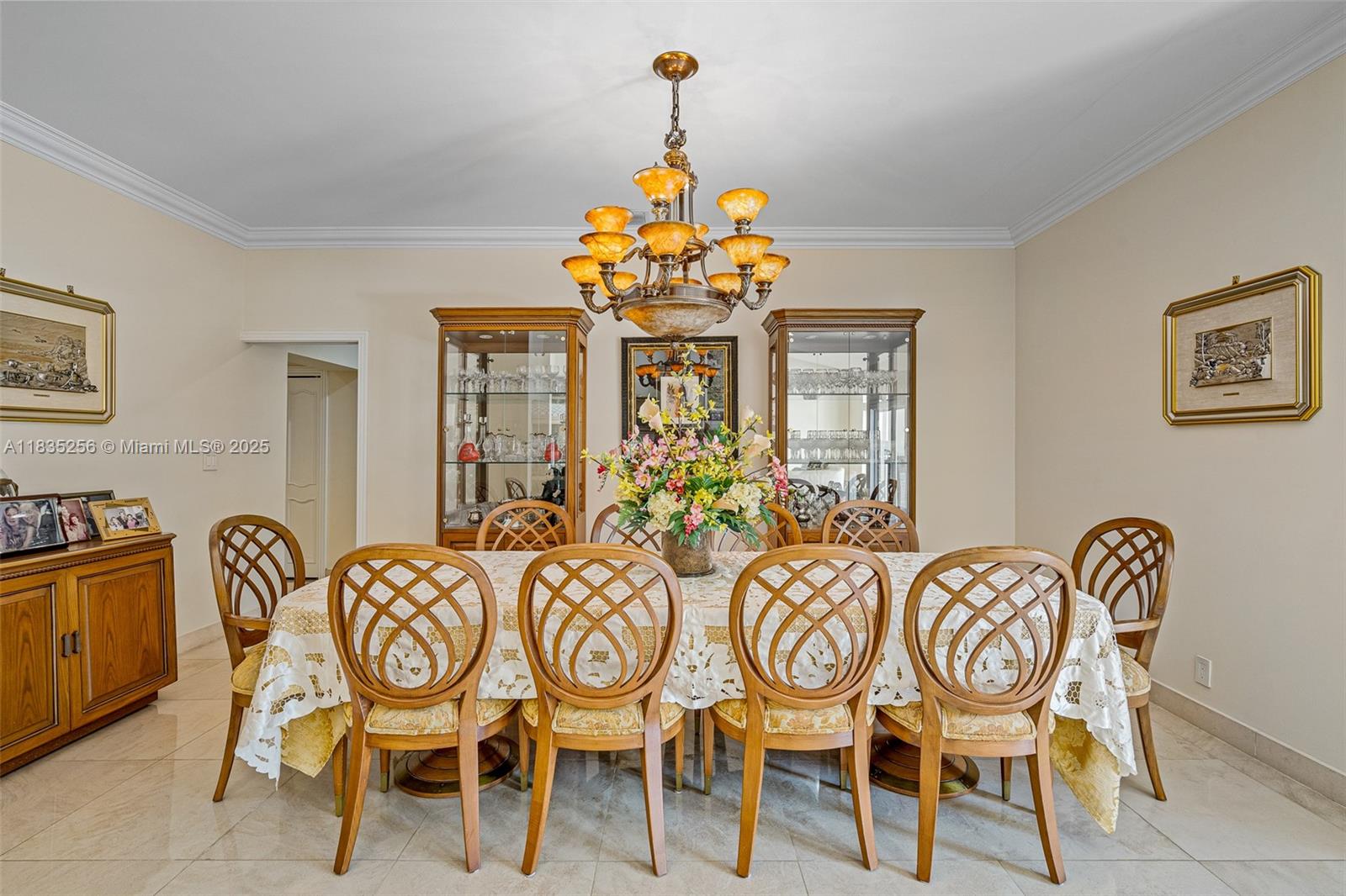 10735 Southwest 58th Avenue Pinecrest, FL 33156 - Photo 16 of 75 a view of a dining room with furniture wooden floor and chandelier