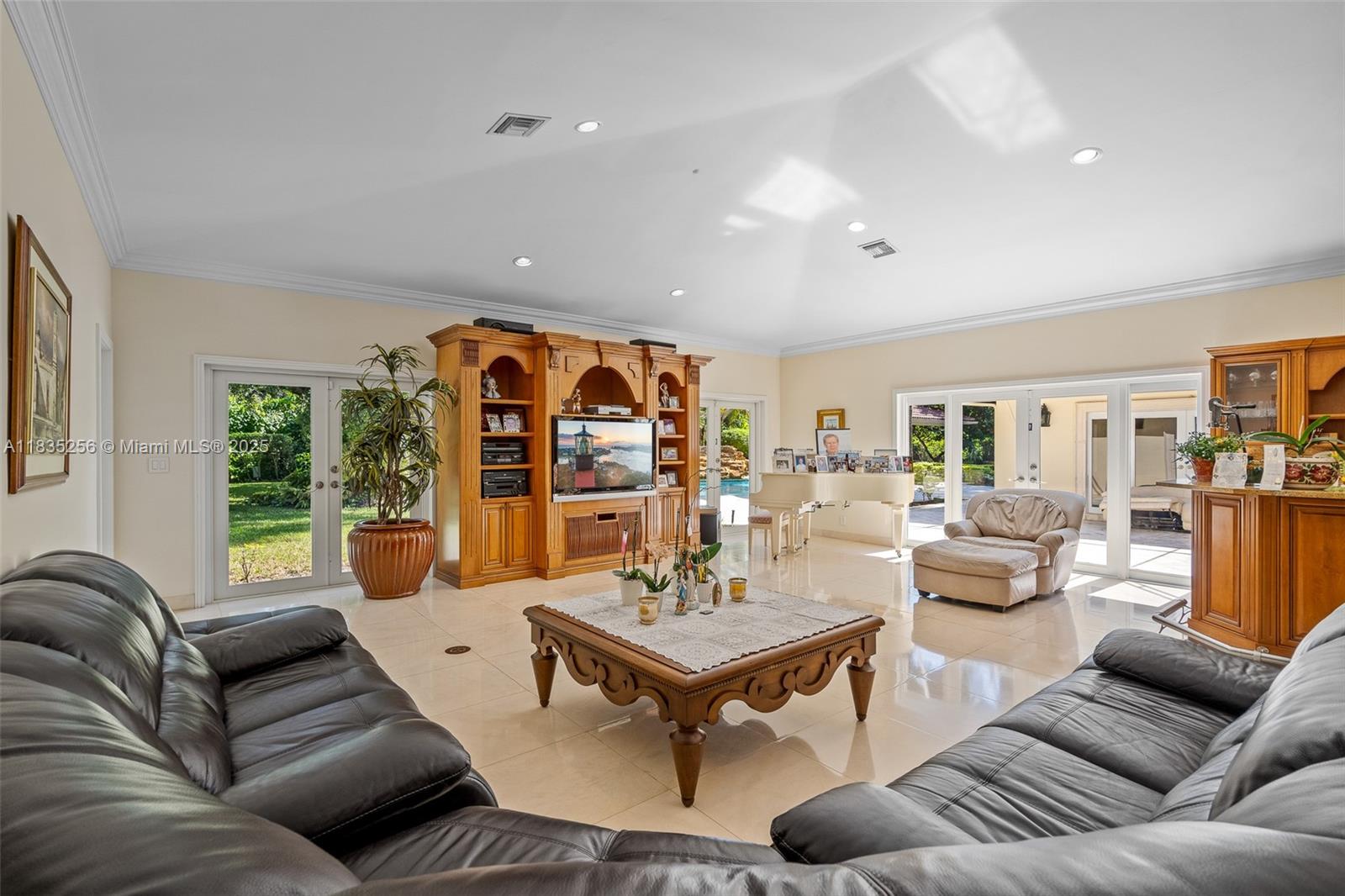 10735 Southwest 58th Avenue Pinecrest, FL 33156 - Photo 28 of 75 a living room with furniture and a large window