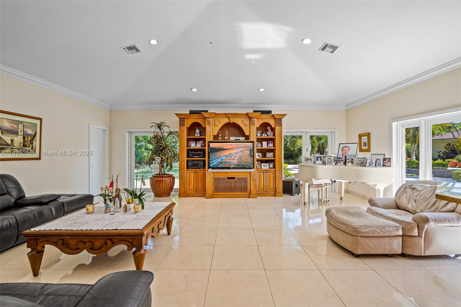 10735 Southwest 58th Avenue Pinecrest, FL 33156 - Photo 29 of 75 a living room with furniture and a flat screen tv