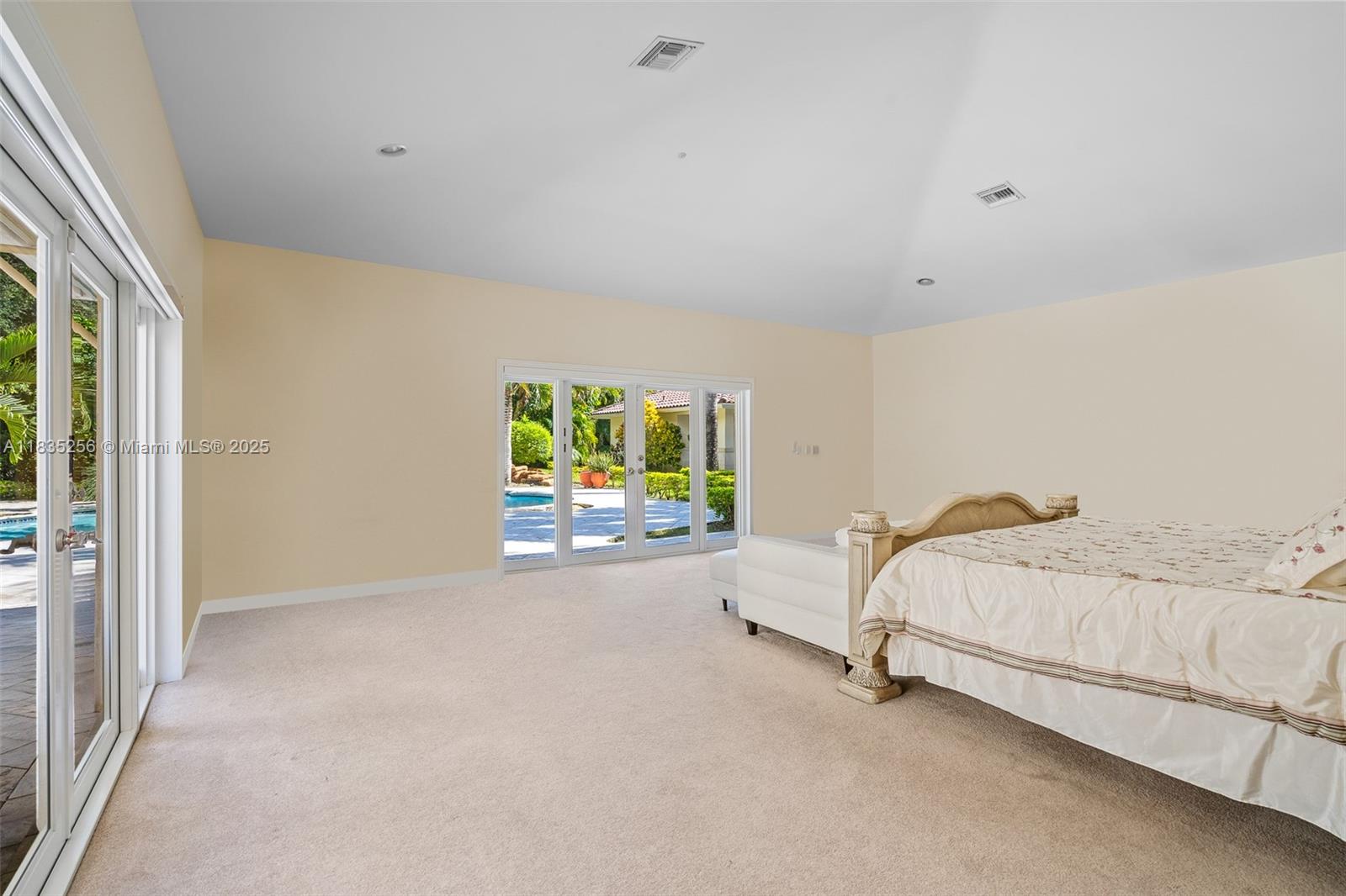 10735 Southwest 58th Avenue Pinecrest, FL 33156 - Photo 34 of 75 a spacious bedroom with a bed and a window