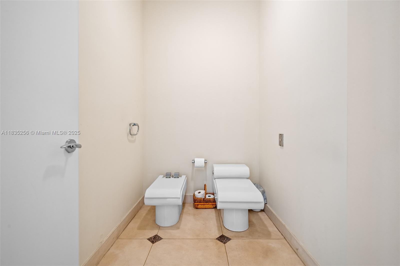 10735 Southwest 58th Avenue Pinecrest, FL 33156 - Photo 44 of 75 a white toilet sitting next to a white wall