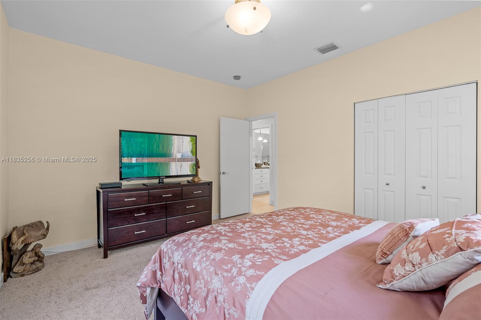 10735 Southwest 58th Avenue Pinecrest, FL 33156 - Photo 53 of 75 a bedroom with a bed and a flat screen tv