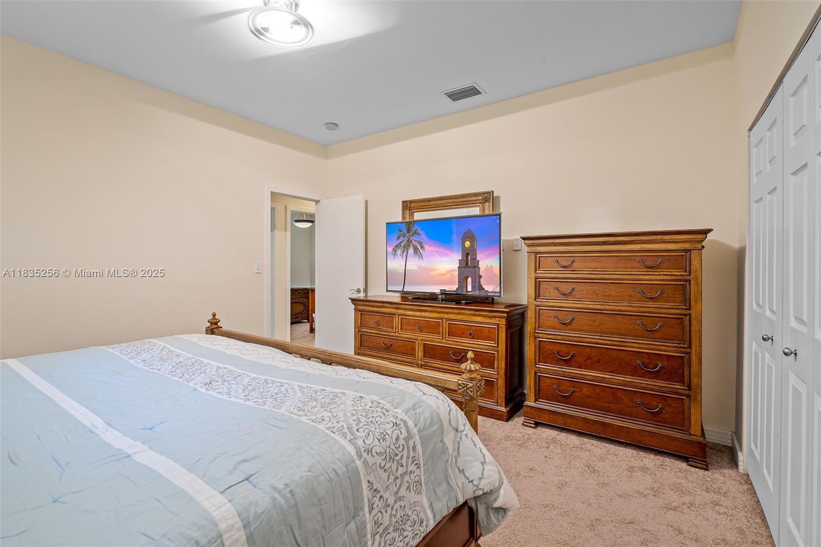 10735 Southwest 58th Avenue Pinecrest, FL 33156 - Photo 56 of 75 a bedroom with a bed and a dresser