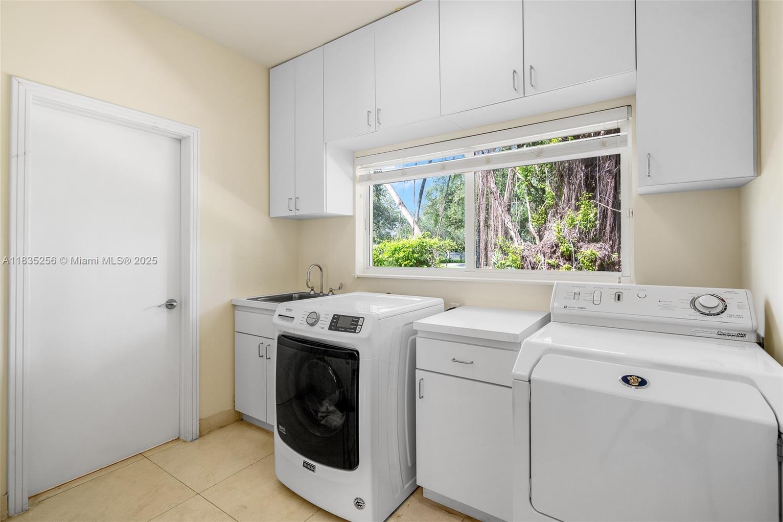 10735 Southwest 58th Avenue Pinecrest, FL 33156 - Photo 57 of 75 a utility room with dryer and washer