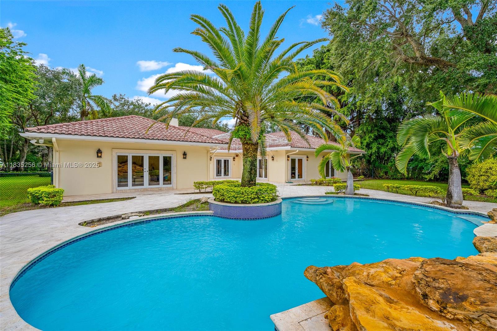 10735 Southwest 58th Avenue Pinecrest, FL 33156 - Photo 63 of 75 a view of a house with swimming pool and a yard