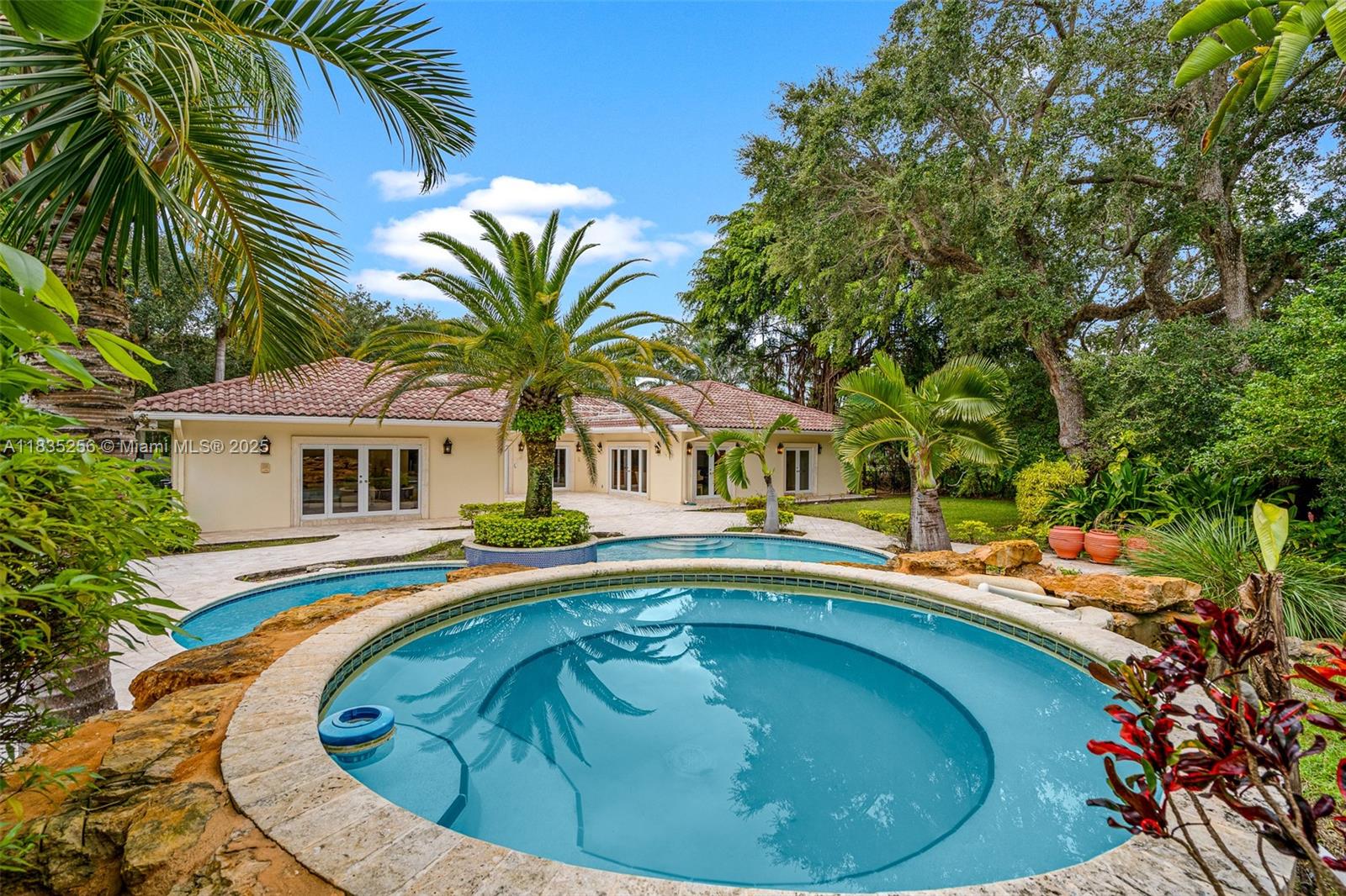 10735 Southwest 58th Avenue Pinecrest, FL 33156 - Photo 64 of 75 a view of swimming pool with a garden