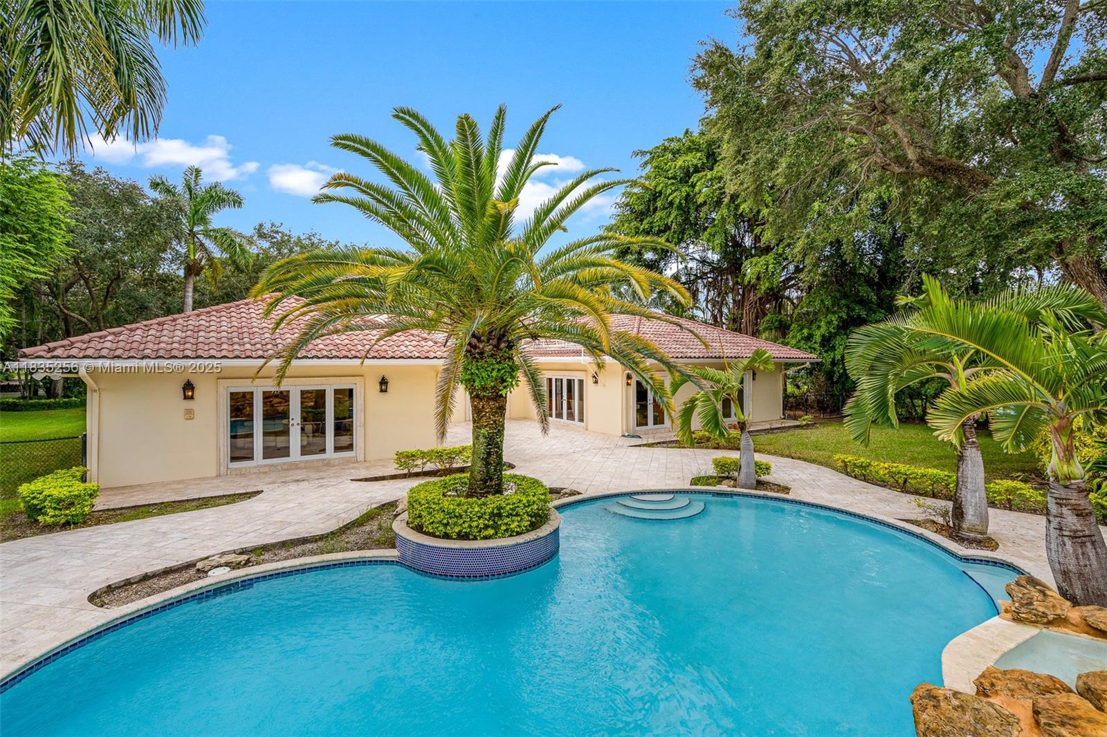 10735 Southwest 58th Avenue Pinecrest, FL 33156 - Photo 65 of 75 a front view of house with yard and trees