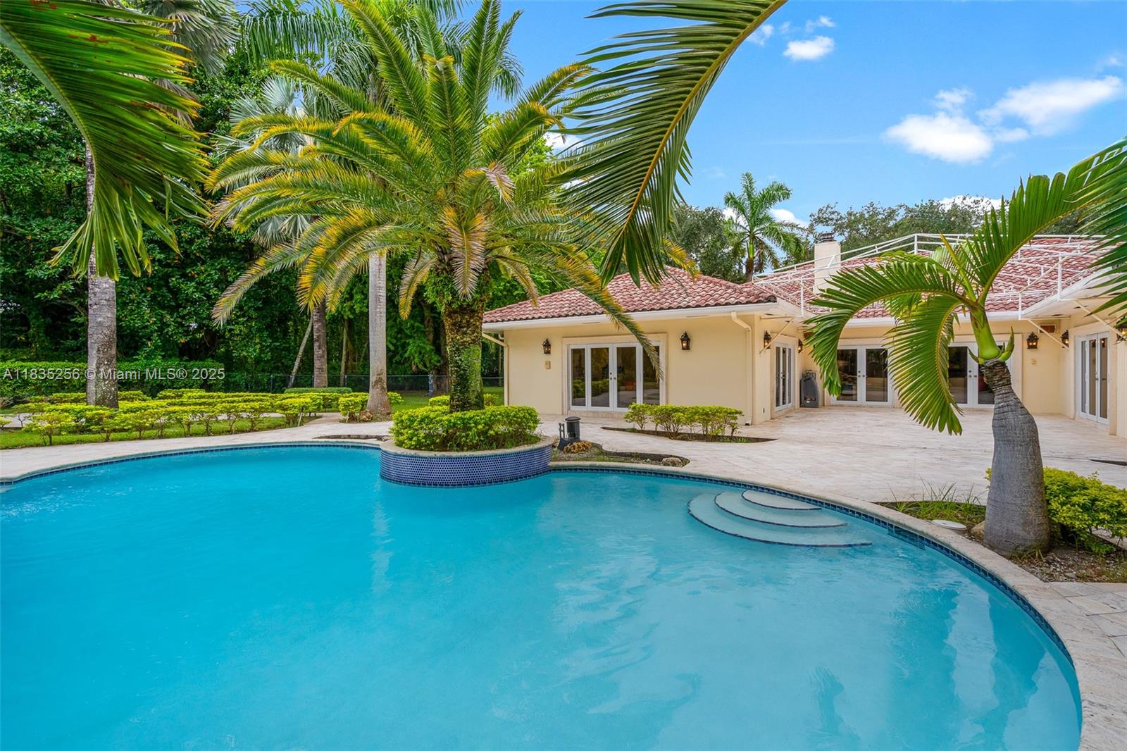 10735 Southwest 58th Avenue Pinecrest, FL 33156 - Photo 67 of 75 a view of a house with swimming pool and sitting area