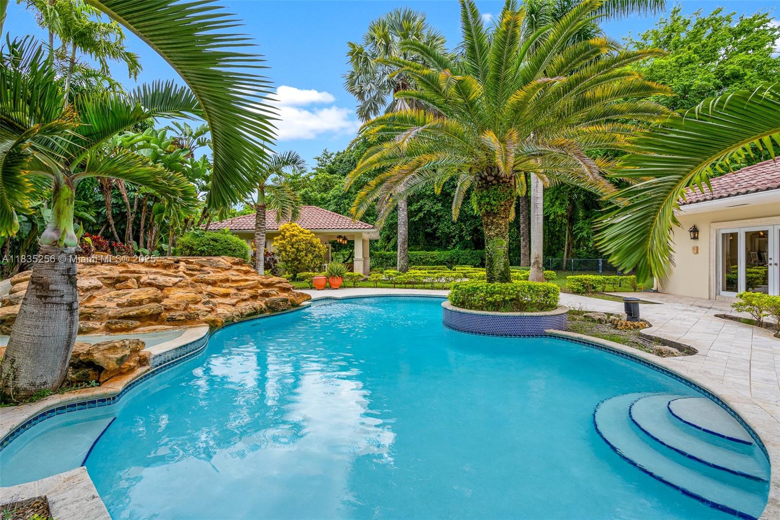 10735 Southwest 58th Avenue Pinecrest, FL 33156 - Photo 68 of 75 a view of a swimming pool with lounge chair