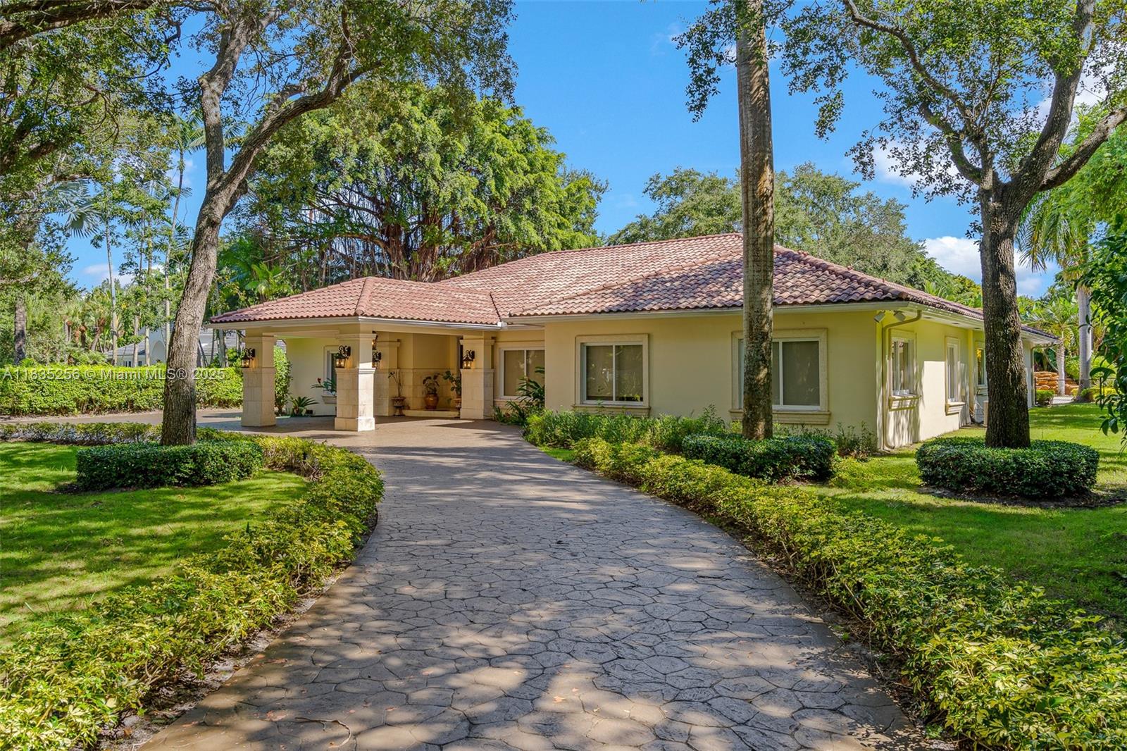 10735 Southwest 58th Avenue Pinecrest, FL 33156 - Photo 8 of 75 a front view of a house with a yard and porch