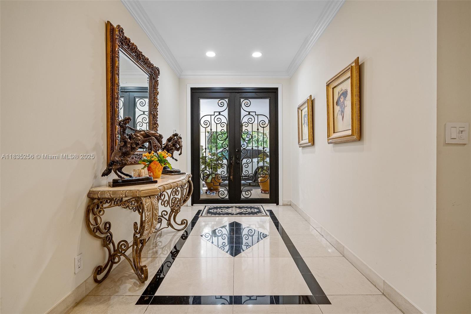 10735 Southwest 58th Avenue Pinecrest, FL 33156 - Photo 9 of 75 a view of a hallway with furniture and floor to ceiling window